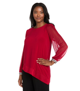 Asymmetrical blouse with long sleeves and shiny cuffs.