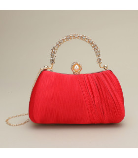 Bolso de mano con asa y cierre de perla adornado con diamantes