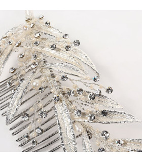 Comb of pearls and crystals among long, thin leaves