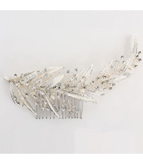 Comb of pearls and crystals among long, thin leaves